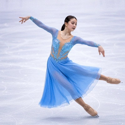 Figure skater in a beautifully designed dress performing on ice, capturing grace and movement